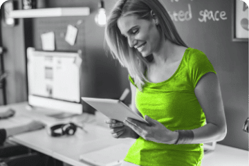 Woman smiling at tablet in office